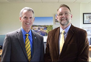 The current president of National Park College, John Hogan, left, stands with the newly named president, Wade Derden, in the college's presidential office on Monday. Derden will assume the role of president on July 1. (The Sentinel-Record/Donald Cross)